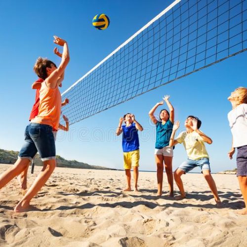 boys-girls-playing-volleyball-beach-big-group-teenage-129655434